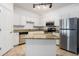 Kitchen with an island, stainless steel appliances, granite countertops, and white cabinetry at 1850 Cotillion Dr # 4218, Atlanta, GA 30338