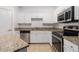 Bright kitchen features white cabinets, stainless appliances, and granite countertops at 1850 Cotillion Dr # 4218, Atlanta, GA 30338