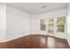 Living room with hardwood floors and lots of natural light coming in from the balcony at 1850 Cotillion Dr # 4218, Atlanta, GA 30338