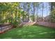 Serene backyard with lush greenery and a tall wooden fence, ideal for privacy and relaxation at 4856 Saddlerun Ln, Powder Springs, GA 30127