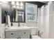 Modern bathroom with navy walls, white tile, and updated fixtures, including a single sink and toilet at 4856 Saddlerun Ln, Powder Springs, GA 30127