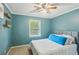 Bright bedroom with a blue accent wall, a ceiling fan, and a plush-looking bed at 4856 Saddlerun Ln, Powder Springs, GA 30127