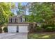 Charming two-story home with a two-car garage and beautifully landscaped front yard at 4856 Saddlerun Ln, Powder Springs, GA 30127