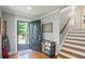 Open foyer features hardwood floors, staircase, and coat closet at 4856 Saddlerun Ln, Powder Springs, GA 30127