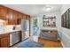 Updated kitchen with stainless steel fridge, white countertops, open shelving, and access to the back deck at 4856 Saddlerun Ln, Powder Springs, GA 30127