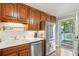 Updated kitchen with stainless steel appliances, wood cabinets, white countertops, and access to backyard deck at 4856 Saddlerun Ln, Powder Springs, GA 30127