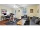 Versatile bonus room with a treadmill, home office setup, and a relaxing lounge area at 4856 Saddlerun Ln, Powder Springs, GA 30127