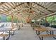 Community pavilion with picnic tables, ceiling fans, fireplace, and pool in the background at 4856 Saddlerun Ln, Powder Springs, GA 30127