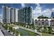 Scenic aerial view of modern high-rise buildings overlooking a landscaped park with a water feature, showcasing urban living at 3481 Lakeside Ne Dr # 1103, Atlanta, GA 30326