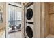 Bright bathroom boasts a stacked washer and dryer, and access to a private balcony at 3481 Lakeside Ne Dr # 1103, Atlanta, GA 30326