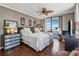 Bedroom featuring hardwood floors, neutral decor, and a balcony with skyline views at 3481 Lakeside Ne Dr # 1103, Atlanta, GA 30326