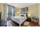 Sunny bedroom features a bed, a bedside table, and a sliding glass door to a balcony at 3481 Lakeside Ne Dr # 1103, Atlanta, GA 30326