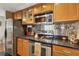 This kitchen features stainless appliances, including a range and microwave, plus wood cabinets at 3481 Lakeside Ne Dr # 1103, Atlanta, GA 30326