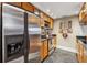Kitchen with stainless steel refrigerator, wooden cabinets, and black countertops at 3481 Lakeside Ne Dr # 1103, Atlanta, GA 30326