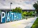 Scenic view of PATH400 with signage, a cyclist, and landscaping, creating a vibrant and inviting public space at 3481 Lakeside Ne Dr # 1103, Atlanta, GA 30326
