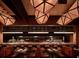 Stylish restaurant interior features unique geometric lighting, comfortable seating, and a view of the chef's area at 3481 Lakeside Ne Dr # 1103, Atlanta, GA 30326