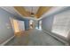 Bedroom featuring tray ceilings, neutral paint, and lots of natural light from windows at 365 Falling Creek Bnd, Duluth, GA 30097