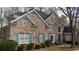 Elegant brick home featuring turquoise shutters, mature trees, and a well-kept yard at 365 Falling Creek Bnd, Duluth, GA 30097