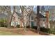 Charming brick home features a well-maintained lawn, mature trees, and architectural details at 365 Falling Creek Bnd, Duluth, GA 30097