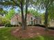 Well maintained brick home with lush lawn, mature trees, and manicured bushes at 365 Falling Creek Bnd, Duluth, GA 30097