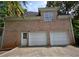 Brick exterior with a two-car garage and access door with a concrete driveway at 365 Falling Creek Bnd, Duluth, GA 30097