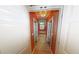 Hallway with hardwood floors and decorative lighting leading to other rooms at 365 Falling Creek Bnd, Duluth, GA 30097