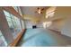 Bright living room with tall windows, a fireplace, and a view of the staircase to the second floor at 365 Falling Creek Bnd, Duluth, GA 30097