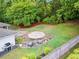 Backyard patio area with grill and an umbrella with seating, perfect for outdoor gatherings at 4855 Kendall Ct, Atlanta, GA 30342