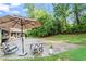 Inviting backyard patio with umbrella, rocking chairs, and a view of the spacious yard at 4855 Kendall Ct, Atlanta, GA 30342