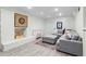 Finished basement rec room with comfortable seating, neutral decor, and painted brick at 4855 Kendall Ct, Atlanta, GA 30342