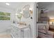 Bright bathroom featuring a double vanity, white subway tile, and a view to the bedroom at 4855 Kendall Ct, Atlanta, GA 30342