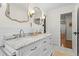 Well-lit bathroom with a double vanity, decorative mirrors, and white subway tile at 4855 Kendall Ct, Atlanta, GA 30342