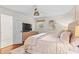 Comfortable bedroom with hardwood floors, a ceiling fan, and view to the ensuite bathroom at 4855 Kendall Ct, Atlanta, GA 30342