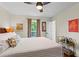 Comfortable bedroom featuring a ceiling fan, view to the back yard, and decor at 4855 Kendall Ct, Atlanta, GA 30342