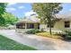 Charming brick home exterior with a screened porch and a large, paved driveway at 4855 Kendall Ct, Atlanta, GA 30342