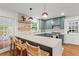 Bright eat-in kitchen features shaker cabinets, quartz counters, and stylish lighting over the island bar at 4855 Kendall Ct, Atlanta, GA 30342