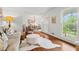 Bright, open-concept living room and dining area, with hardwood floors and large windows at 4855 Kendall Ct, Atlanta, GA 30342