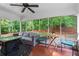 Inviting screened porch with a ceiling fan, comfortable seating, and views of the lush backyard at 4855 Kendall Ct, Atlanta, GA 30342