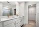 Elegant bathroom with double vanity, white cabinets, quartz countertop and walk-in shower at 517 Hyde Ridge Trl, Loganville, GA 30052