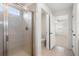 Bathroom featuring tile shower with glass door, toilet and view into main bedroom at 517 Hyde Ridge Trl, Loganville, GA 30052