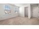 Bright bedroom with neutral carpeting, walk-in closet, and bright windows at 517 Hyde Ridge Trl, Loganville, GA 30052