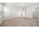 Large bedroom featuring soft carpet, white walls, walk-in closet, and ensuite bathroom at 517 Hyde Ridge Trl, Loganville, GA 30052