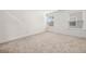 Bright bedroom featuring soft carpet, white walls, baseboards, and natural light at 517 Hyde Ridge Trl, Loganville, GA 30052