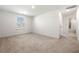 Spacious bedroom with plush carpeting and a view of the en suite bathroom at 517 Hyde Ridge Trl, Loganville, GA 30052