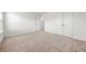 Spacious bedroom featuring neutral carpet, white walls, baseboards, and double doors at 517 Hyde Ridge Trl, Loganville, GA 30052