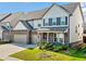 Charming two-story home with a combination brick and siding exterior and a two-car garage, surrounded by a green lawn at 517 Hyde Ridge Trl, Loganville, GA 30052