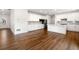 Spacious open concept kitchen featuring stainless steel appliances, quartz counters, and seamless flow to the living area at 517 Hyde Ridge Trl, Loganville, GA 30052