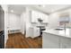 Bright, modern kitchen featuring white cabinets, stainless steel appliances, and a large island with seating at 517 Hyde Ridge Trl, Loganville, GA 30052