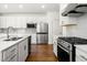 Well-equipped kitchen boasts stainless steel appliances, island, and sleek white cabinetry, perfect for modern living at 517 Hyde Ridge Trl, Loganville, GA 30052