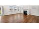 Bright, open living space with hardwood floors, a fireplace, and multiple windows for ample natural light at 517 Hyde Ridge Trl, Loganville, GA 30052